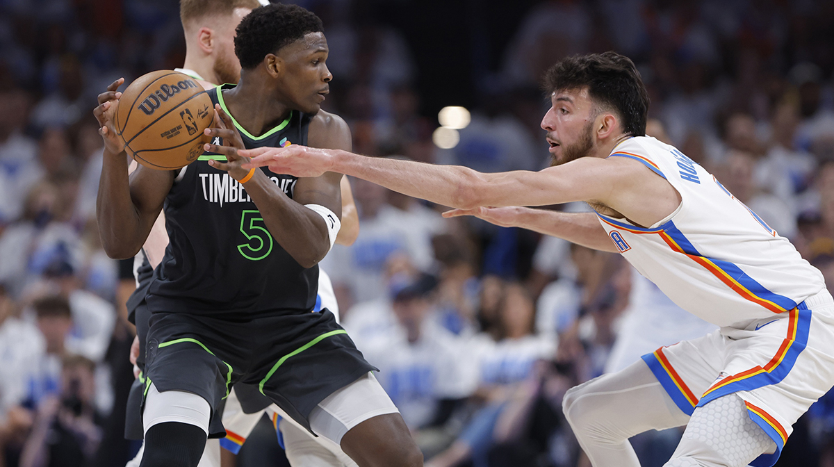 Minnesota Timberwolves guard Anthony Edwards (5) controls the ball against Oklahoma City Thunder forward Chet Holmgren (7) in the fourth quarter during game one of the western conference finals for the 2025 NBA Playoffs at Paycom Center.