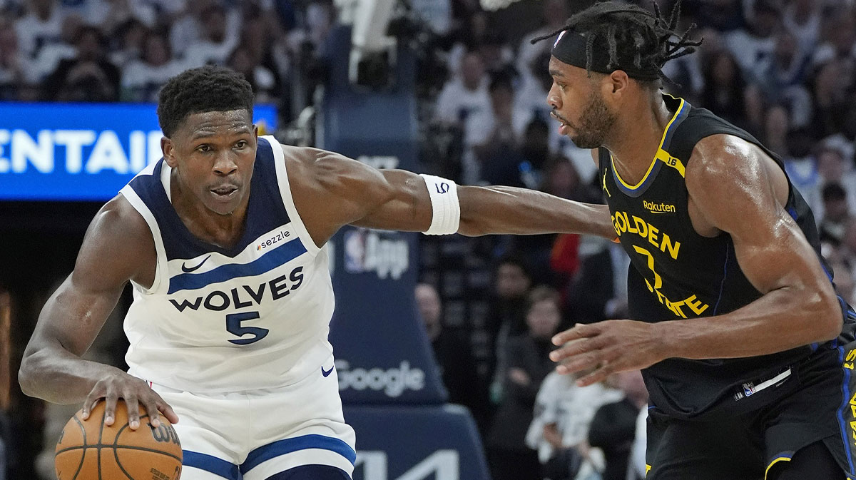Minnesota Timberwolves guard Anthony Edwards (5) dribbles around Golden State Warriors forward Buddy Hield (7) in the first quarter during game one of the second round for the 2025 NBA Playoffs at Target Center.