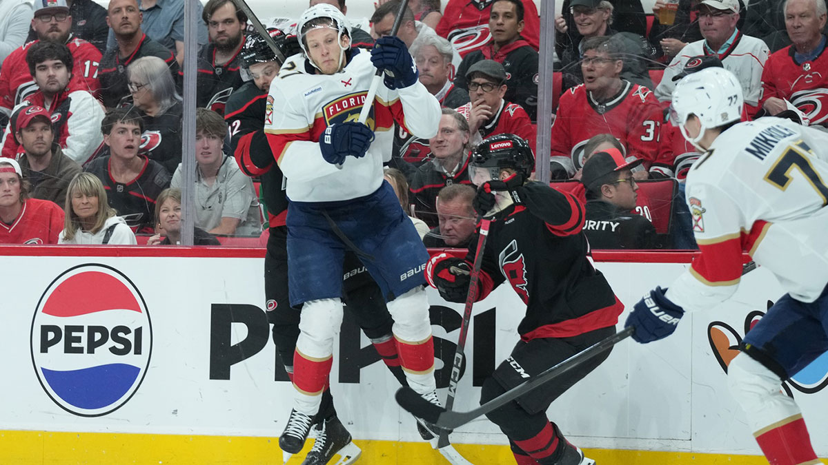 Carolina Hurricanes forward Jesperi Kotkaniemi (82) checks Florida Panthers forward Eetu Luostarinen (27) during the first period in game five of the Eastern Conference Final of the 2025 Stanley Cup Playoffs at Lenovo Center.