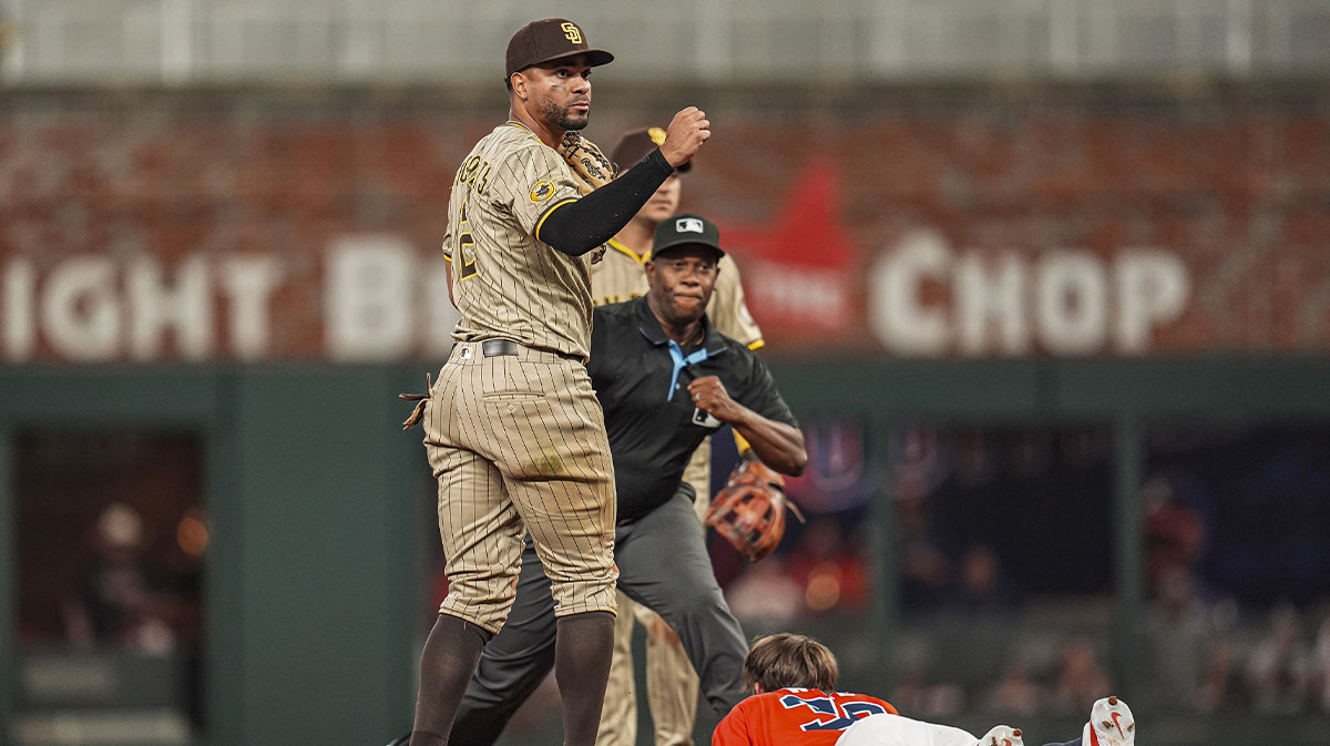 San Diego Padres shortstop Xander Bogaerts (2) tags out Atlanta Braves pinch runner Eli White (36) during the ninth inning at Truist Park.