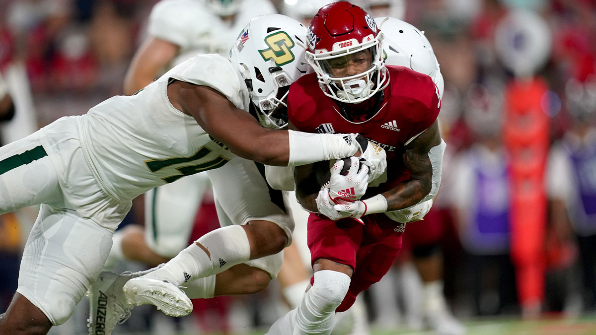 Fresno State Bulldogs wide receiver Jalen Moreno-Cropper (5) is tackled by Cal Poly Mustangs defensive lineman Elijah Ponder (14) after making a catch in the third quarter at Valley Children's Stadium.
