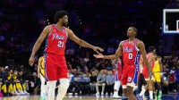 Philadelphia 76ers center Joel Embiid (21) and guard Tyrese Maxey (0) slap hands after a play against the Indiana Pacers during the first quarter at Wells Fargo Center.