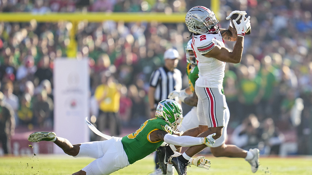 Ohio State Buckeyes wide receiver Emeka Egbuka (2) catches a pass over Oregon Ducks defensive back Nikko Reed (9) during the first half of the College Football Playoff quarterfinal at the Rose Bowl in Pasadena, Calif. on Jan. 1, 2025.