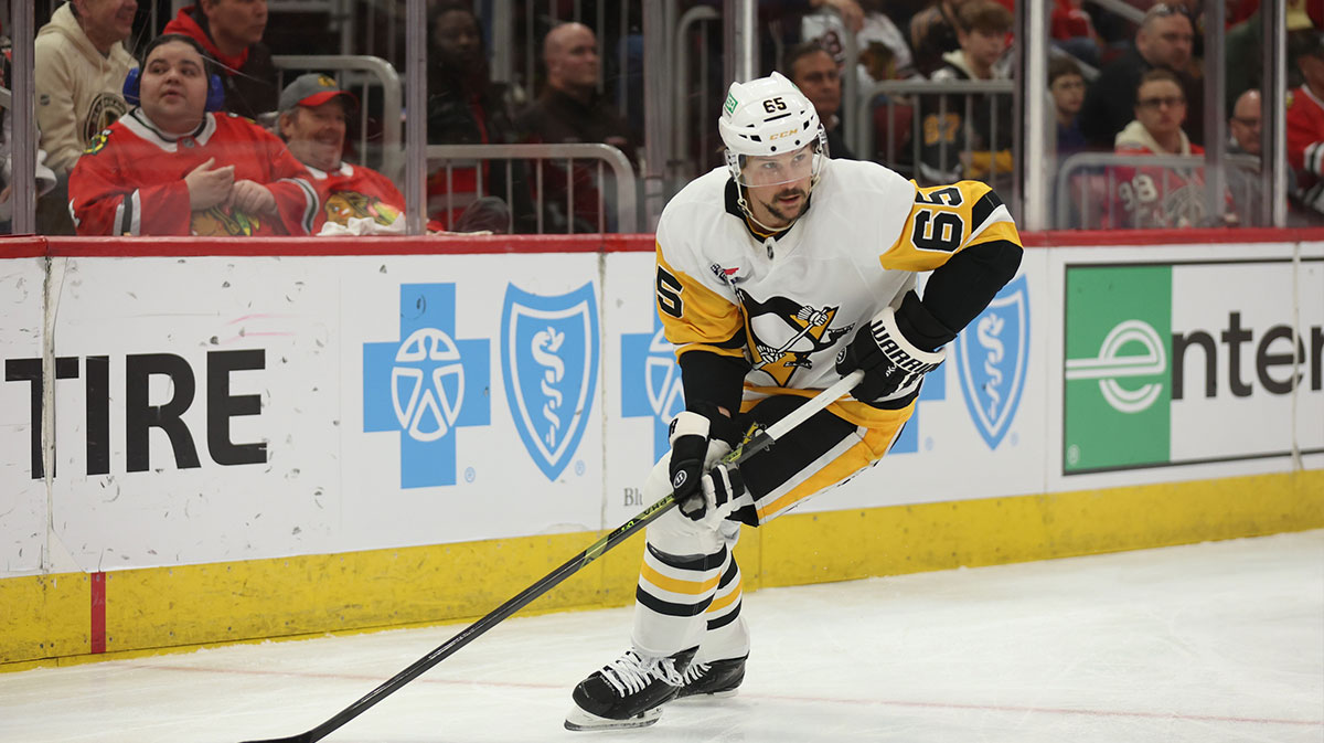 Pittsburgh Penguins defenseman Erik Karlsson (65) clears the puck during the first period against the Chicago Blackhawks at United Center.