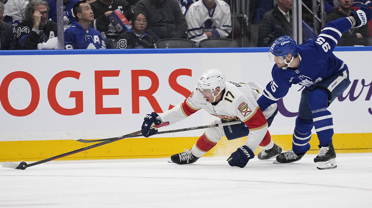Florida Panthers forward Evan Rodrigues (17) is checked by Toronto Maple Leafs defenseman Oliver Ekman-Larsson (95) during the second period of the second round of the 2025 Stanley Cup Playoffs at Scotiabank Arena.