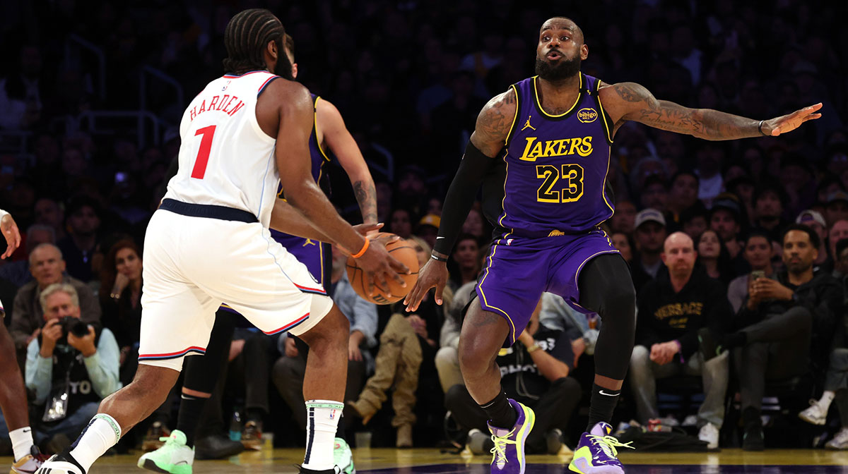 Feb 28, 2025; Los Angeles, California, USA; Los Angeles Lakers forward LeBron James (23) defends LA Clippers guard James Harden (1) during the fourth quarter at Crypto.com Arena. Mandatory Credit: Jason Parkhurst-Imagn Images