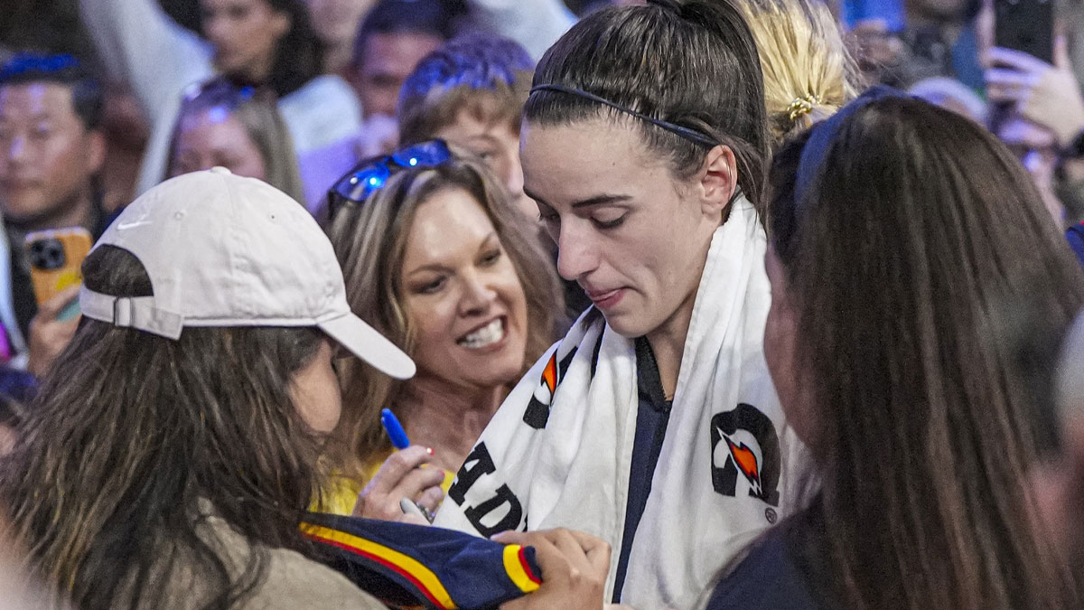 May 10, 2025; Atlanta, GA, USA; Indiana Fever guard Caitlin Clark (22) signs autographs on her way off the court after the Fever defeated the Atlanta Dream at Gateway Center Arena @ College Park. Mandatory Credit: Dale Zanine-Imagn Images