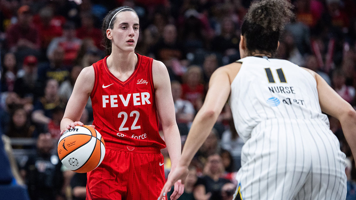 Indiana Fever guard Caitlin Clark (22) dribbles the ball while Chicago Sky guard Kia Nurse (11) defends in the first half at Gainbridge Fieldhouse.