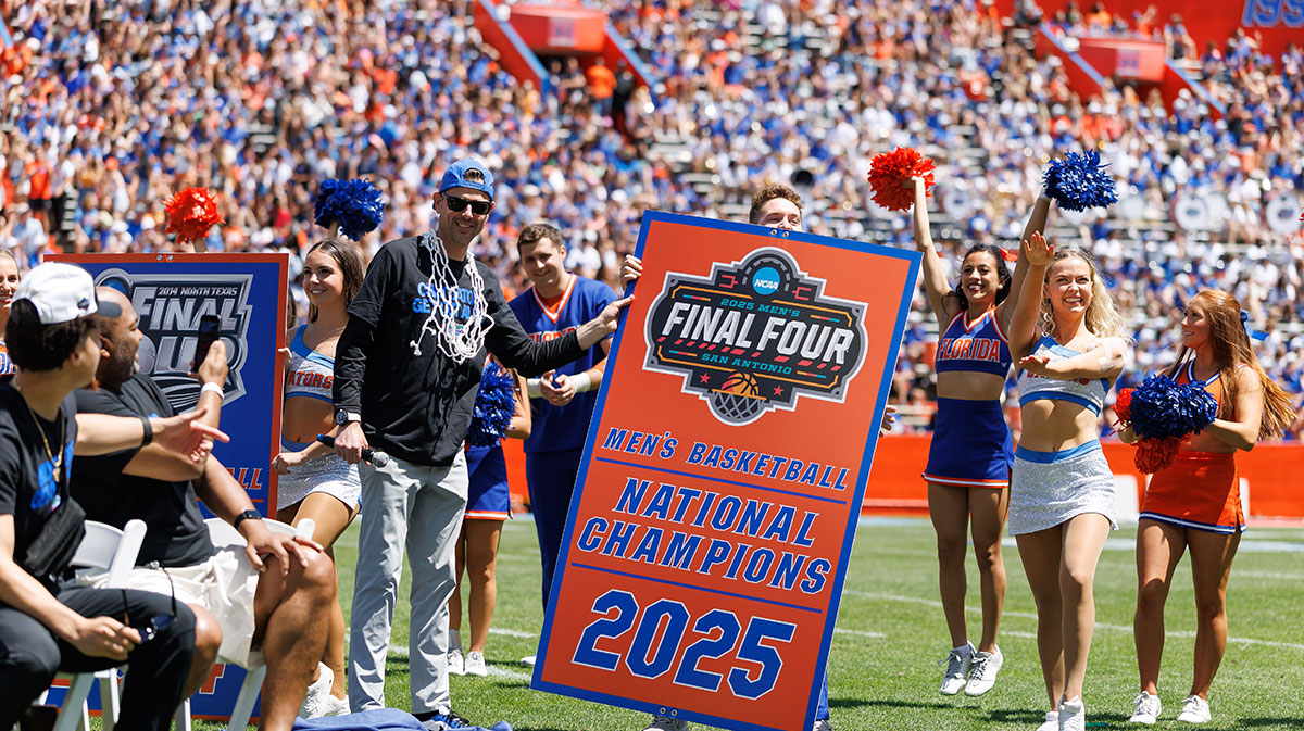 Florida Gators head coach Todd Golden holds the new National Championship banner during the National Championship celebration at Ben Hill Griffin Stadium.