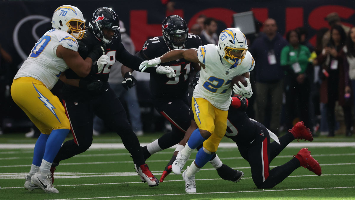 Los Angeles Chargers running back J.K. Dobbins (27) runs the ball during the first quarter against the Houston Texans in the first quarter in an AFC wild card game at NRG Stadium.
