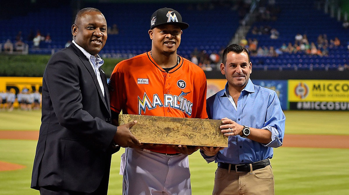 Miami Marlins president of baseball operations Michael Hill (L) and President David Samson (R) present Miami Marlins starting pitcher Edinson Volquez (36) with the pitching rubber taken from the mound after throwing a no hitter in the game against the Arizona Diamondbacks on June 3, 2017 at Marlins Park. Le Batard
