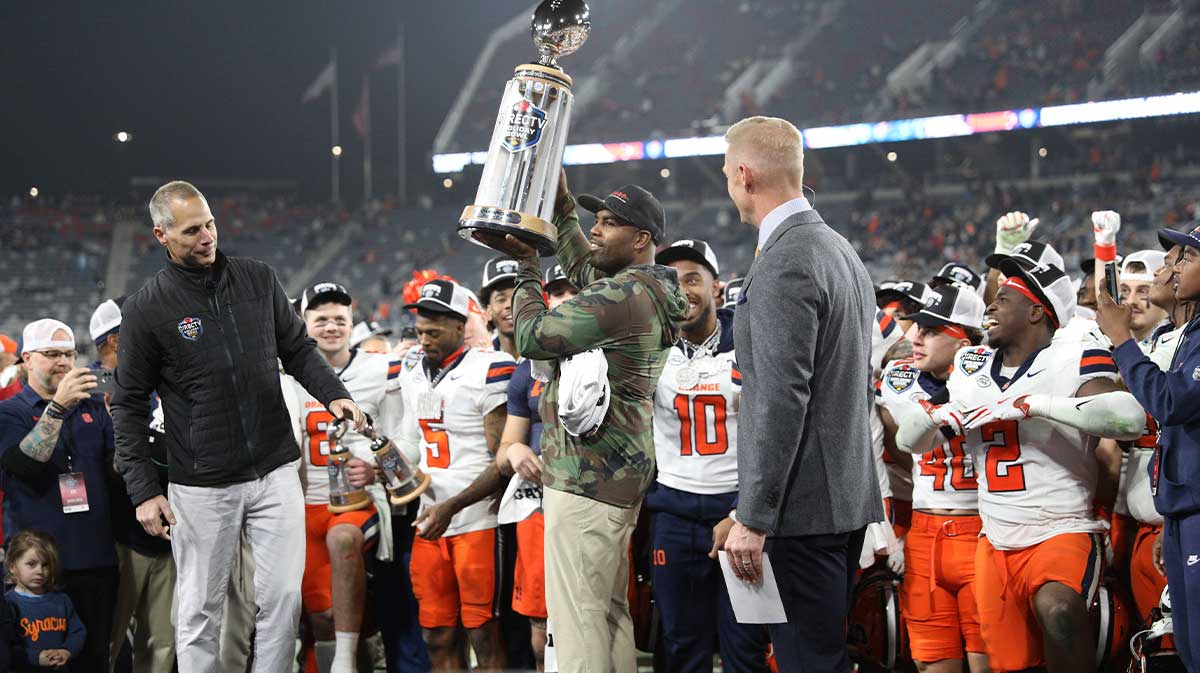 Syracuse Orange head coach Fran Brown raises the Holiday Bowl trophy after defeating the Washington State Cougars after the game at Snapdragon Stadium.