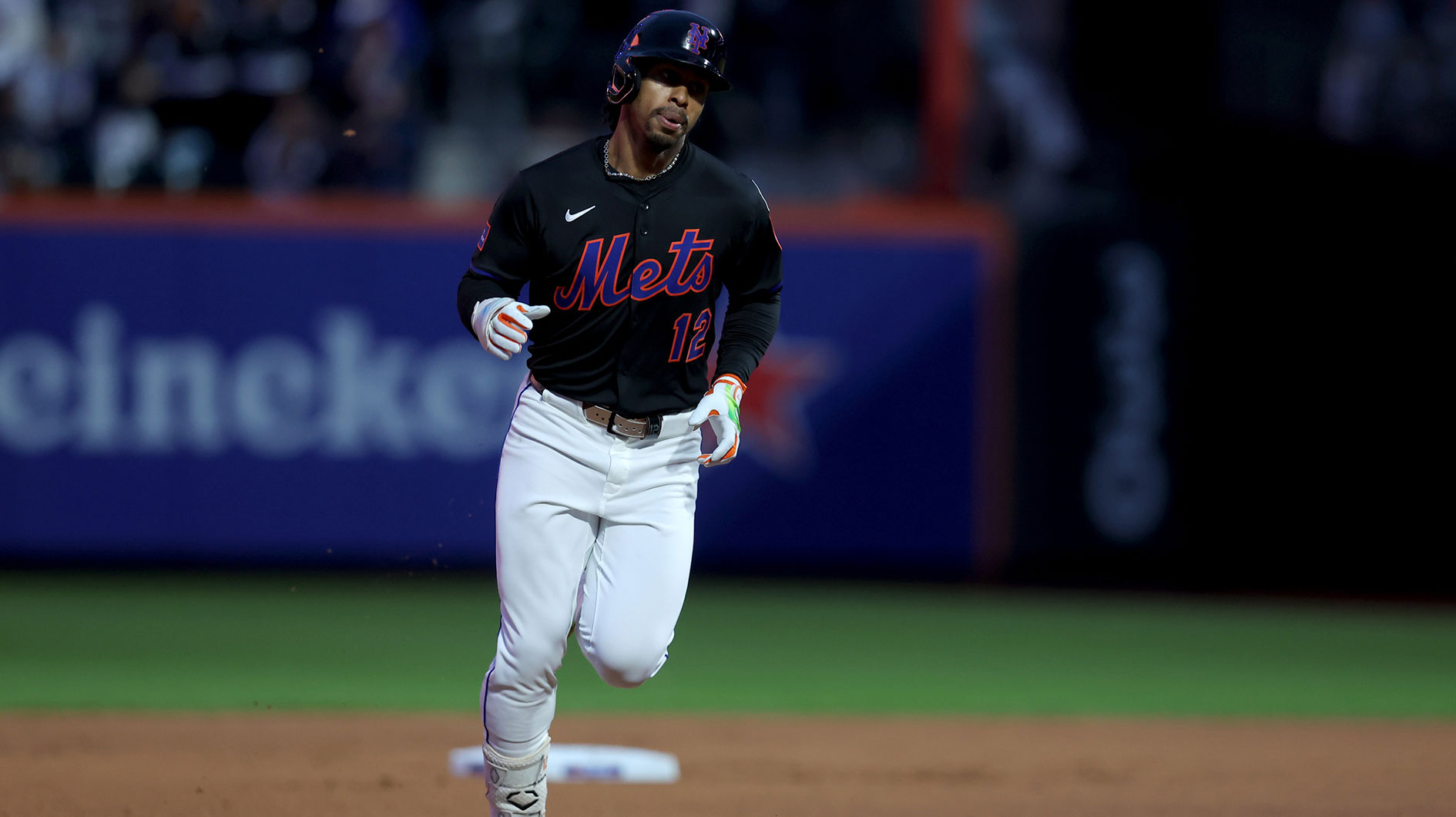 New York Mets shortstop Francisco Lindor (12) rounds the bases after hitting a solo home run against the Chicago Cubs during the first inning.