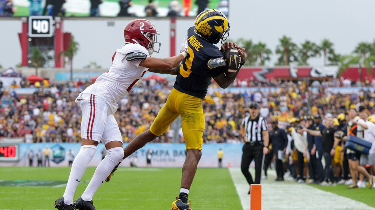 Michigan Wolverines wide receiver Fredrick Moore (3) catches a pass for a touchdown against the Alabama Crimson Tide in the first quarter during the ReliaQuest Bowl at Raymond James Stadium.