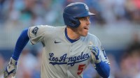 Los Angeles Dodgers first baseman Freddie Freeman (5) runs toward third base after hitting a three-run triple against the Miami Marlins during the seventh inning at loanDepot Park.