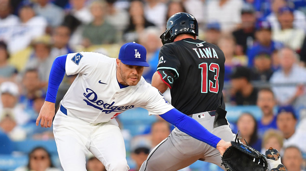 Arizona Diamondbacks second base Tim Tawa (13) is safe at first against Los Angeles Dodgers first base Freddie Freeman (5) in the second inning at Dodger Stadium.