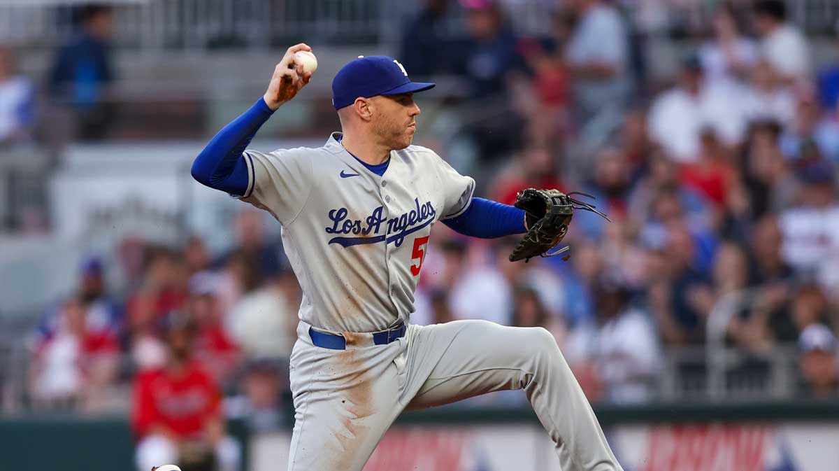 Los Angeles Dodgers first baseman Freddie Freeman (5) throws a runner out at first against the Atlanta Braves in the third inning at Truist Park.
