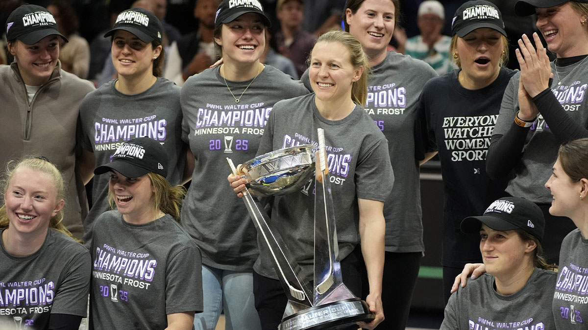 Minnesota Frost captain Kendall Coyne Schofield joined by her teammates carries the Walter Cup which they won the the night before during a break of the game between the Seattle Storm and the Minnesota Lynx at Target Center.