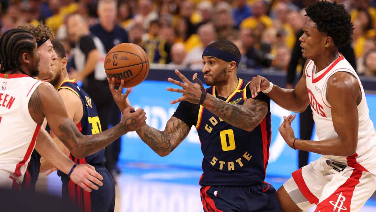 Golden State Warriors guard Gary Payton II (0) controls a rebound between Houston Rockets guard Jalen Green (4) and forward/guard Amen Thompson (1) during the fourth quarter of game four of the 2025 NBA Playoffs.