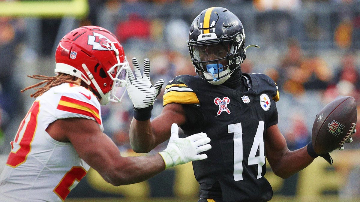 Pittsburgh Steelers wide receiver George Pickens (14) runs after a catch as Kansas City Chiefs safety Justin Reid (20) defends during the fourth quarter at Acrisure Stadium.
