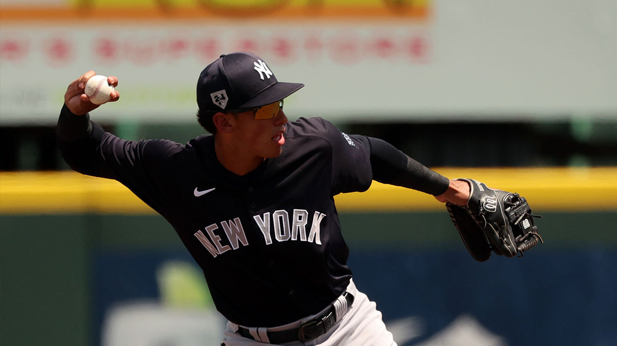 New York Yankees infielder George Lombard Jr. (18) throws the ball to first base for an out during the fourth inning against the Pittsburgh Pirates.