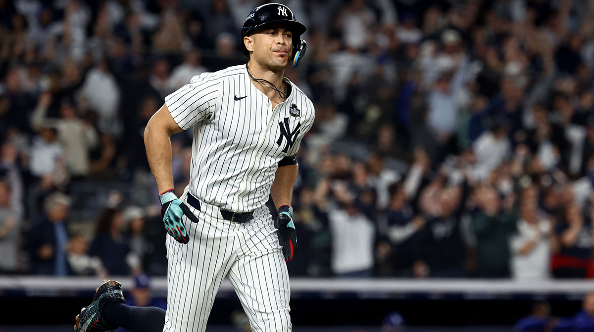 New York Yankees designated hitter Giancarlo Stanton (27) reacts after hitting a home run during the third inning against the Los Angeles Dodgers in game five of the 2024 MLB World Series at Yankee Stadium.