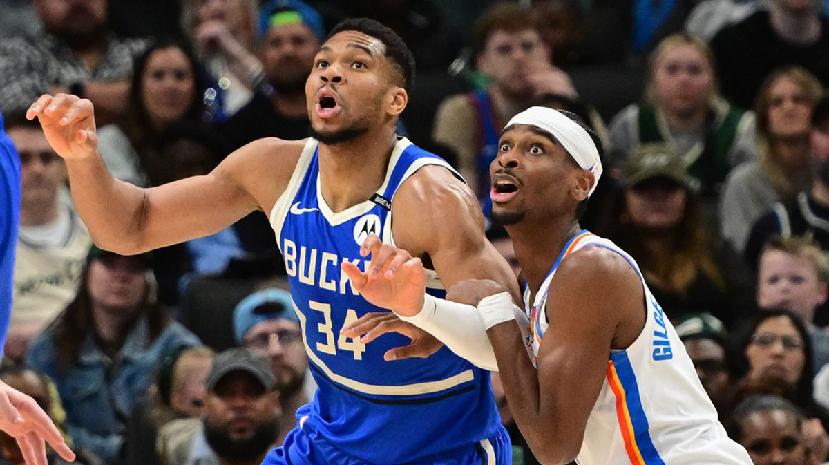 Milwaukee Bucks forward Giannis Antetokounmpo (34) and Oklahoma City Thunder guard Shai Gilgeous-Alexander (2) jostles for position under the basket in the second quarter at Fiserv Forum.