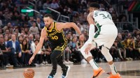 Golden State Warriors guard Stephen Curry (30) dribbles past Milwaukee Bucks forward Giannis Antetokounmpo (34) in the third quarter at the Chase Center.