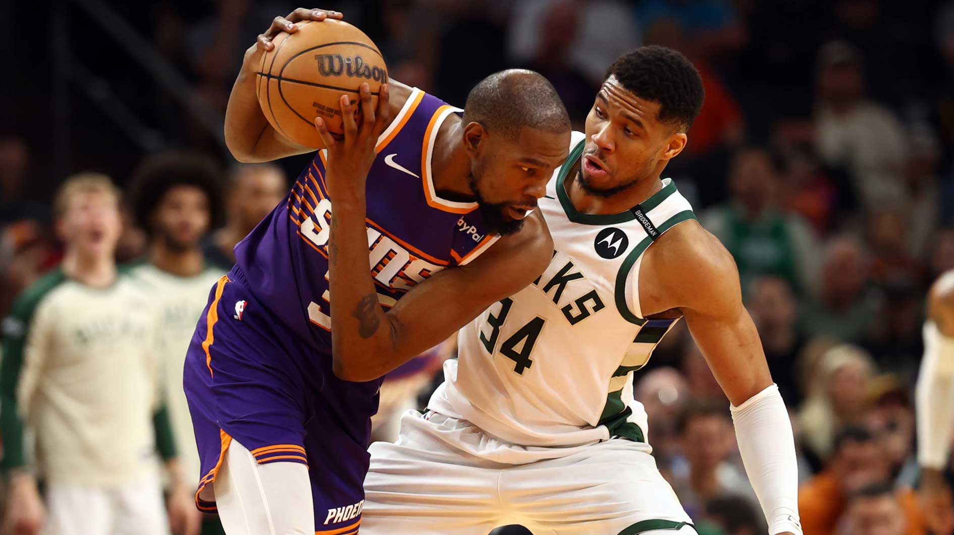 Milwaukee Bucks forward Giannis Antetokounmpo (34) defends against Phoenix Suns forward Kevin Durant (35) at Footprint Center.