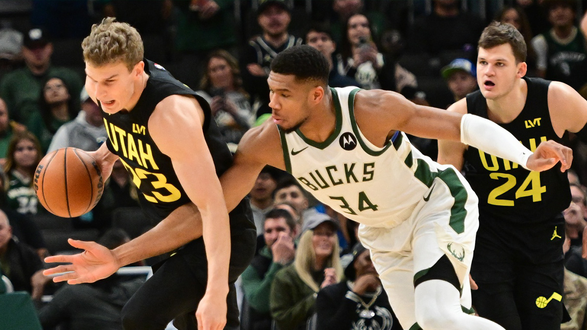 USA; Milwaukee Bucks forward Giannis Antetokounmpo (34) tries to steal the ball from Utah Jazz forward Lauri Markkanen (23) in the first quarter at Fiserv Forum.