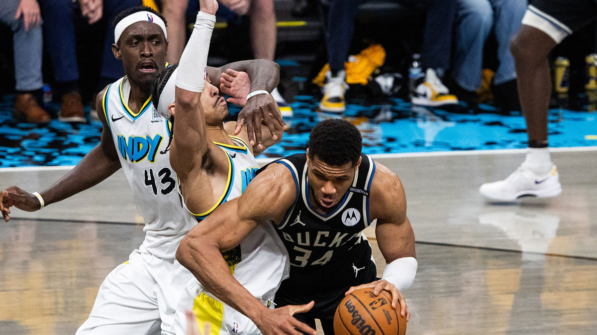 Milwaukee Bucks forward Giannis Antetokounmpo (34) dribbles the ball while Indiana Pacers guard Andrew Nembhard (2) defends during game five of the first round for the 2024 NBA Playoffs at Gainbridge Fieldhouse.