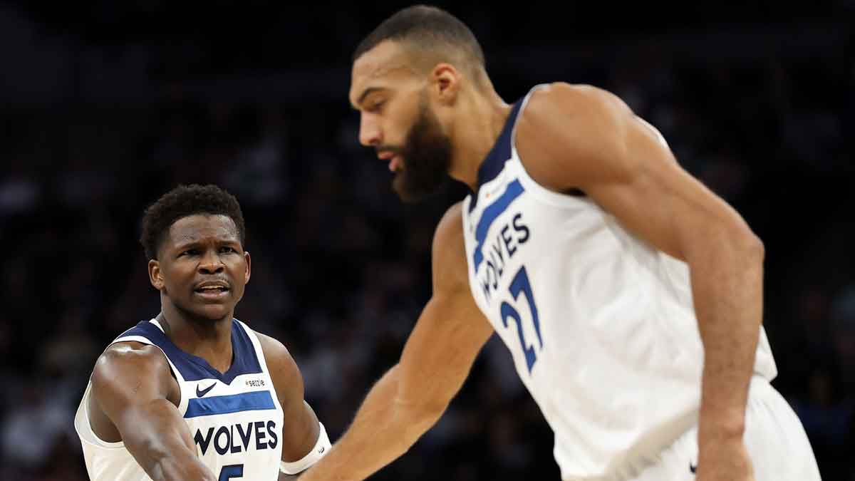 Minnesota Timberwolves guard Anthony Edwards (5) talks to center Rudy Gobert (27) during the first quarter against the Detroit Pistons at Target Center.