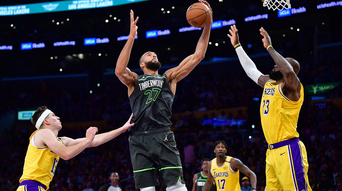 Minnesota Timberwolves center Rudy Gobert (27) gets the rebound against Los Angeles Lakers guard Austin Reaves (15) and forward LeBron James (23) during the second half in game five of first round for the 2025 NBA Playoffs at Crypto.com Arena.