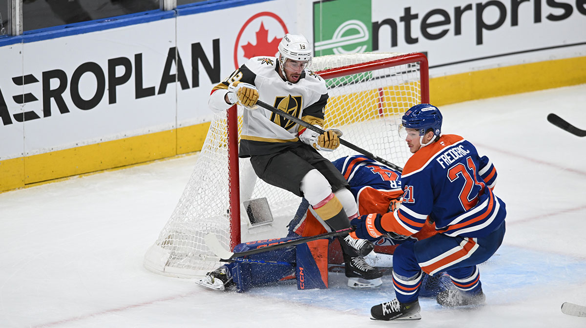 Edmonton Oilers goalie Stuart Skinner (74) battles for the puck with Vegas Golden Knights right winger Reilly Smith (19) with Oilers centre Brett Frederic (21) looking on during the first period in game three of the second round of the 2025 Stanley Cup Playoffs at Rogers Place.