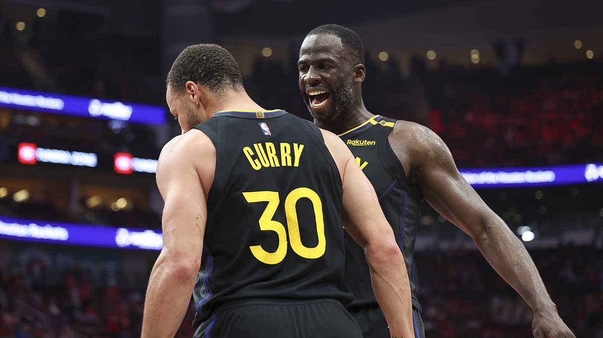 Golden State Warriors forward Draymond Green (23) celebrates with guard Stephen Curry (30) during game seven of the first round for the 2025 NBA Playoffs against the Houston Rockets at Toyota Center.