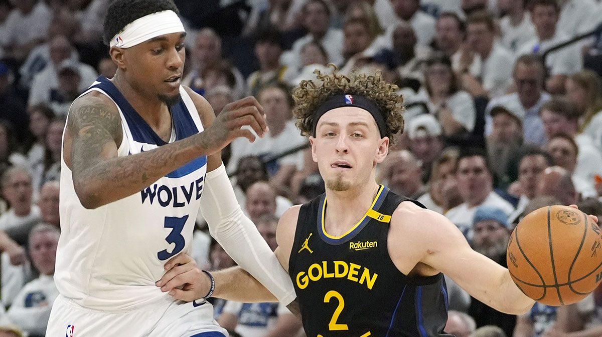 Golden State Warriors guard Brandin Podziemski (2) dribbles past Minnesota Timberwolves forward Jaden McDaniels (3) in the third quarter during game one of the second round for the 2025 NBA Playoffs at Target Center.