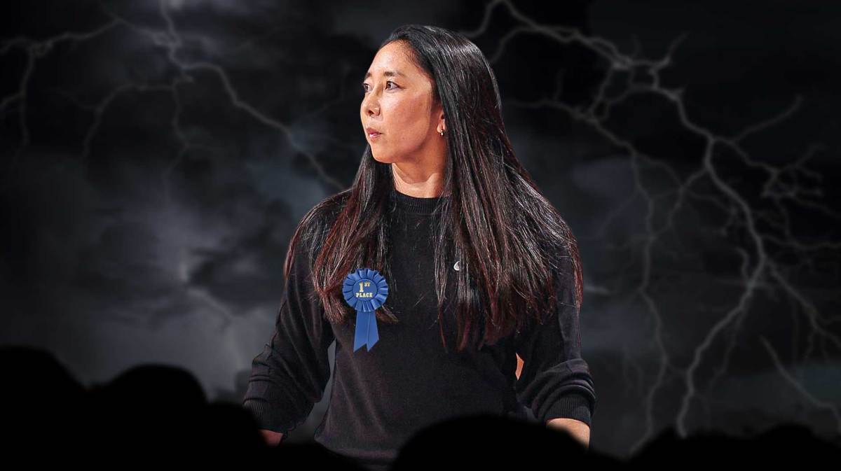 Valkyries Natalie Nakase with a first-place ribbon and a heavy rain storm around her.