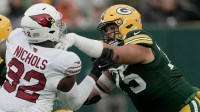 Green Bay Packers guard Sean Rhyan (75) blocks Arizona Cardinals defensive tackle Bilal Nichols (92) during the first quarter of their game Sunday, October 13, 2024 at Lambeau Field in Green Bay, Wisconsin.