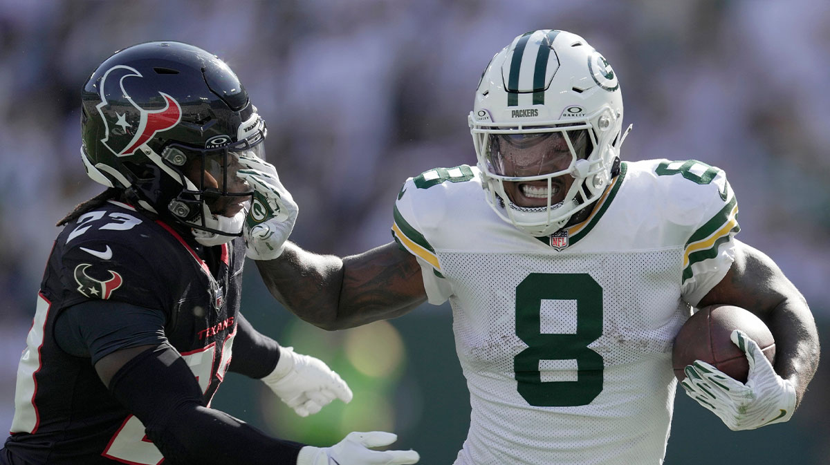 Green Bay Packers running back Josh Jacobs (8) stiff-arms Houston Texans safety Eric Murray (23) during the third quarter of their game Sunday, October 20, 2024 at Lambeau Field in Green Bay, Wisconsin.