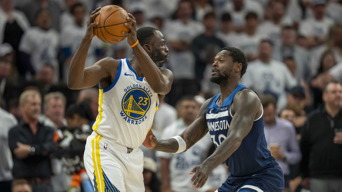 Golden State Warriors forward Draymond Green (23) holds the ball up as Minnesota Timberwolves forward Julius Randle (30) plays defense in the first half during game five of the second round for the 2025 NBA Playoffs at Target Center.