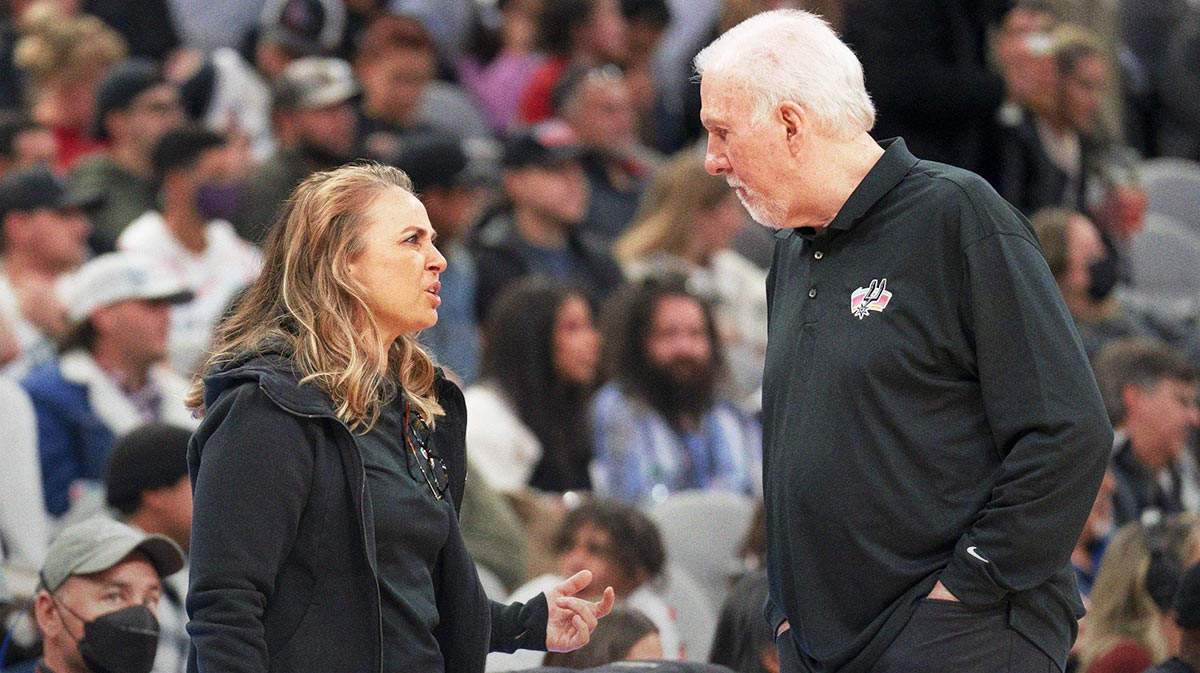 San Antonio Spurs head coach Gregg Popovich talks with assistant coach Becky Hammon during the first half against the Utah Jazz at AT&T Center.