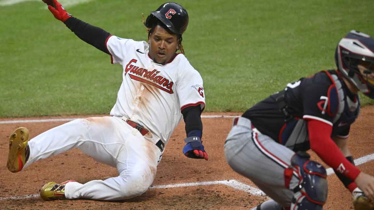 Cleveland Guardians third baseman Jose Ramirez (11) scores against Minnesota Twins catcher Ryan Jeffers (27) in the seventh inning at Progressive Field.