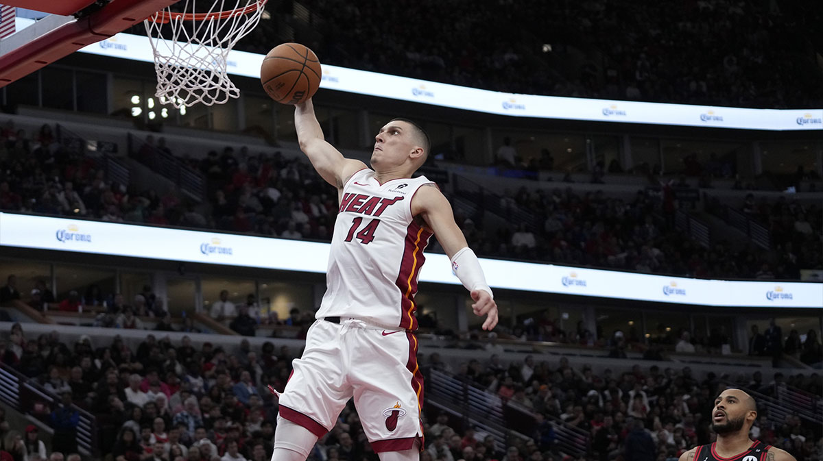 Miami Heat guard Tyler Herro (14) goes up for a dunk on Chicago Bulls forward Talen Horton-Tucker (22) during the second half at United Center.