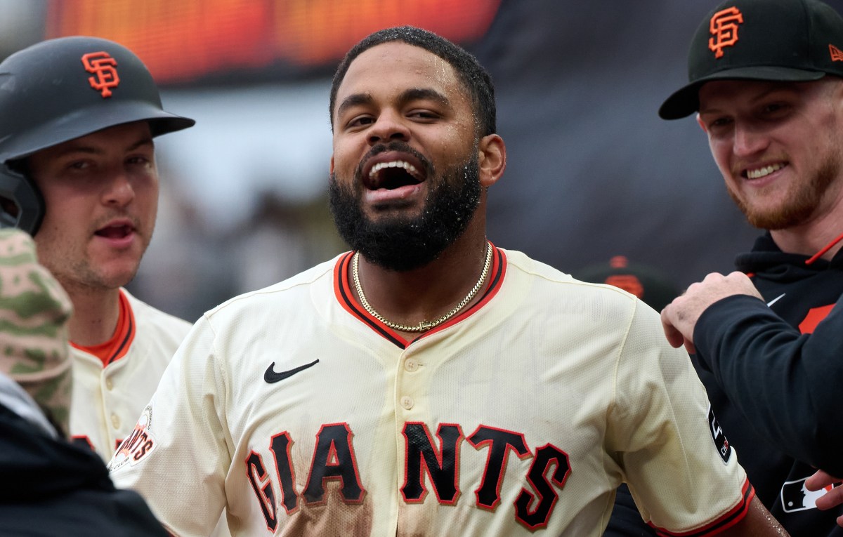 Apr 27, 2025; San Francisco, California, USA; San Francisco Giants outfielder Heliot Ramos (17) celebrates with catcher Patrick Bailey (14) and catcher Sam Huff (23) after scoring the game-winning run against the Texas Rangers during the ninth inning at Oracle Park. Mandatory Credit: Robert Edwards-Imagn Images