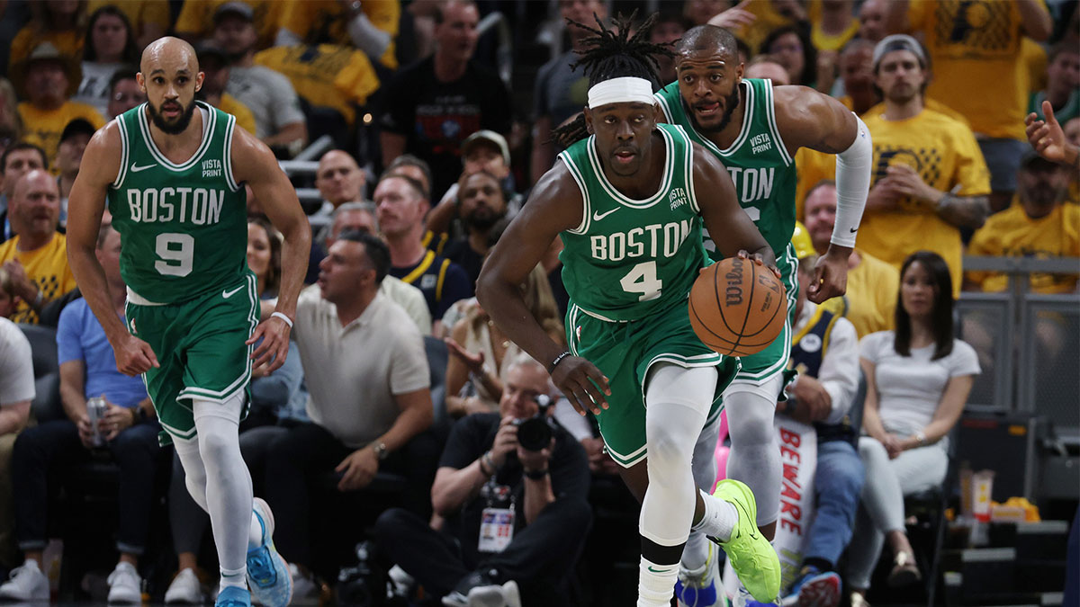Boston Celtics guard Jrue Holiday (4) brings the bal up court with guard Derrick White (9) and forward Xavier Tillman (26) against the Indiana Pacers during the third quarter of game three of the eastern conference finals in the 2024 NBA playoffs at Gainbridge Fieldhouse.
