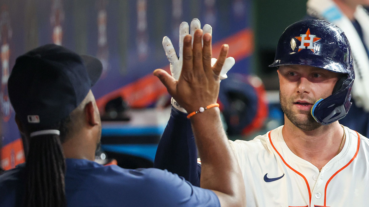 Houston Astros first baseman Christian Walker (8) celebrates his two-run home run with teammates against the Athletics in the sixth inning at Daikin Park.