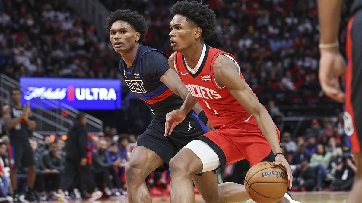 Houston Rockets forward Amen Thompson (1) controls the ball as Detroit Pistons forward Ausar Thompson (9) defends during the third quarter at Toyota Center.
