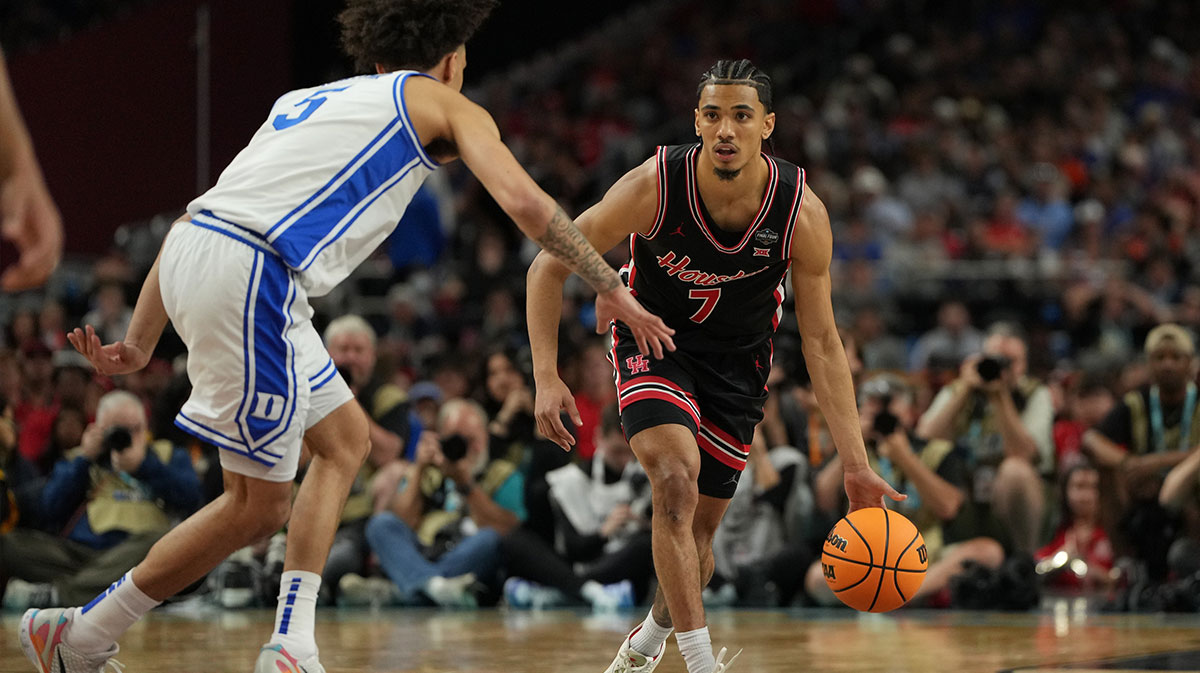 Houston Cougars guard Milos Uzan (7) dribbles the ball against Duke Blue Devils guard Tyrese Proctor (5) during the first half in the semifinals of the men's Final Four of the 2025 NCAA Tournament at the Alamodome.