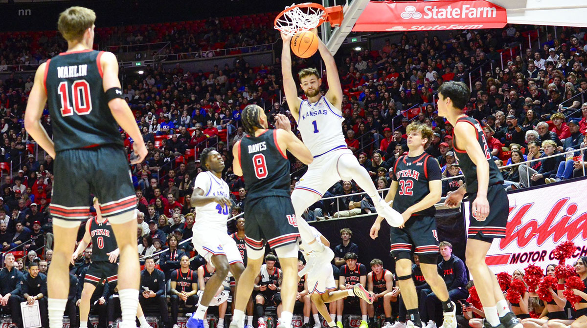 Kansas Jayhawks center Hunter Dickinson (1) dunks over Utah Utes forward Keanu Dawes (8) during the first half at the Jon M. Huntsman Center.