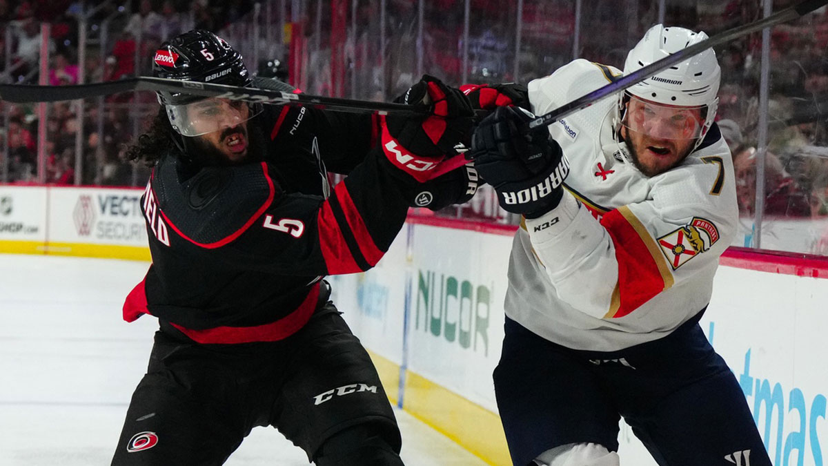 Carolina Hurricanes defenseman Jalen Chatfield (5) and Florida Panthers defenseman Dmitry Kulikov (7) battle during the second period at PNC Arena.